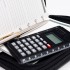 Calculator, pen and agenda in black organizer case Calculator, pen and agenda in black organizer case