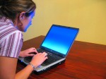 A Woman Typing on a Laptop A Woman on a Computer